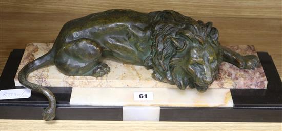 A bronzed spelter figure of a lion on marble base length 49cm